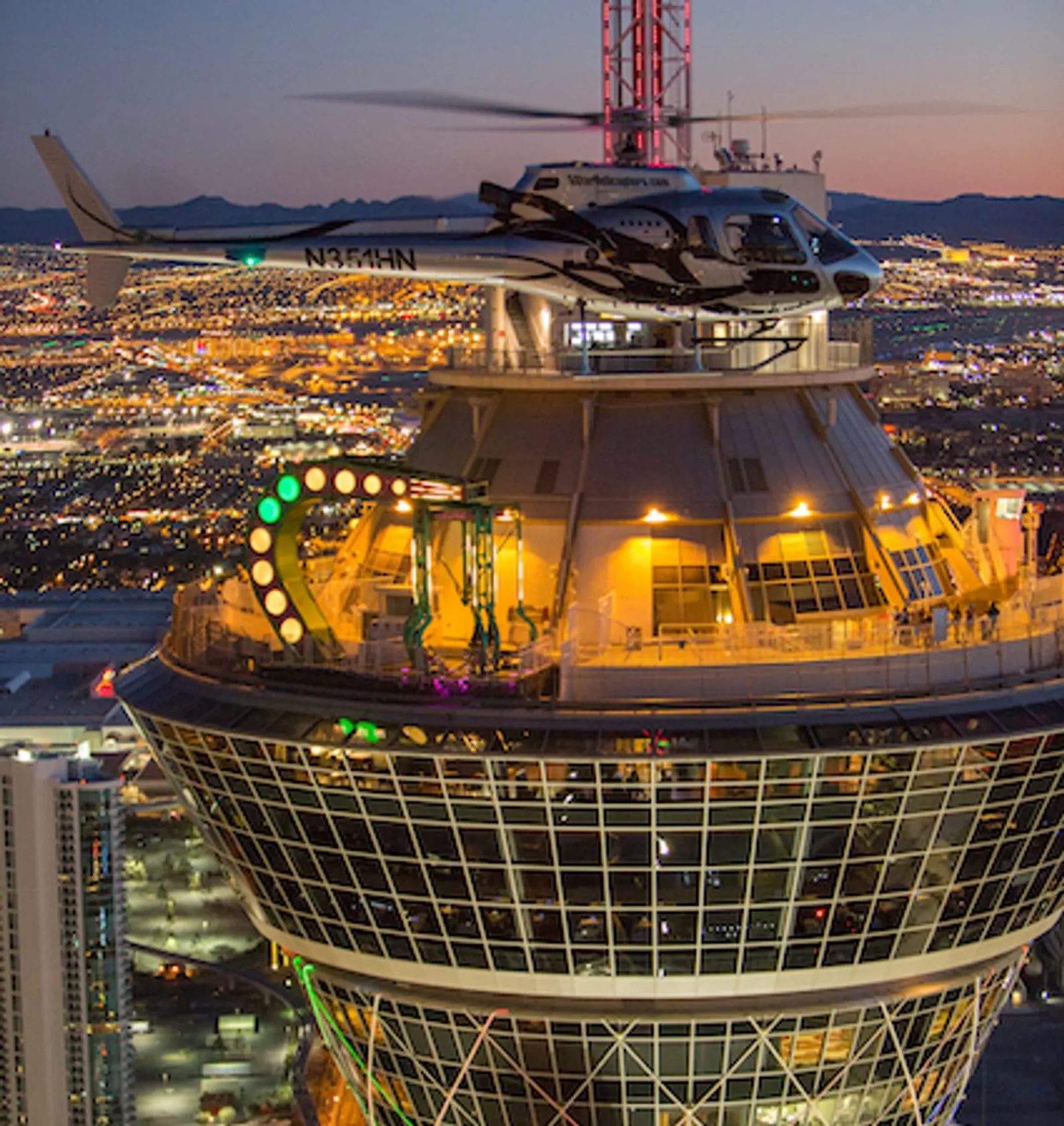 Helicopter passing the Strat tower at night